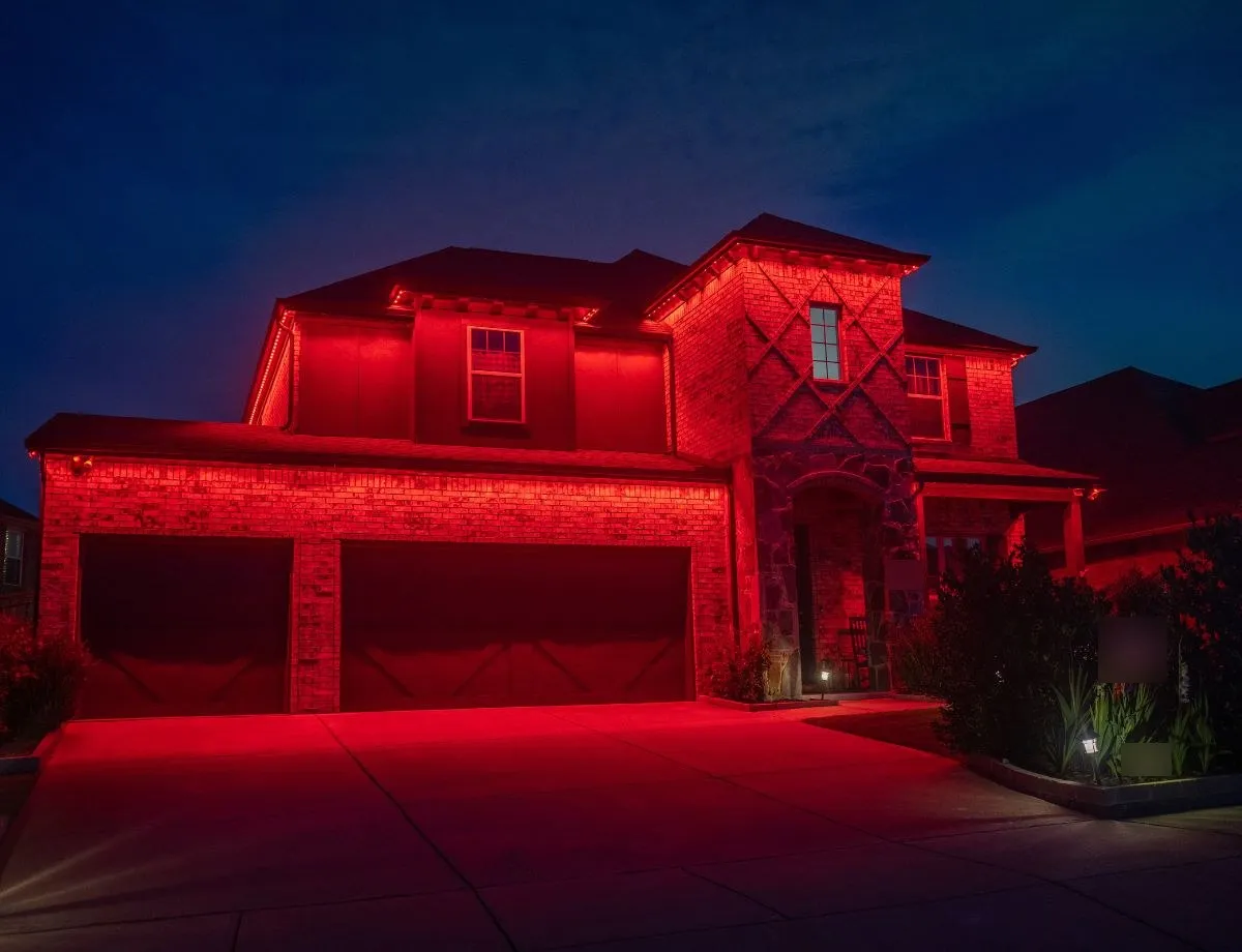 Two-story home lit in red for game day