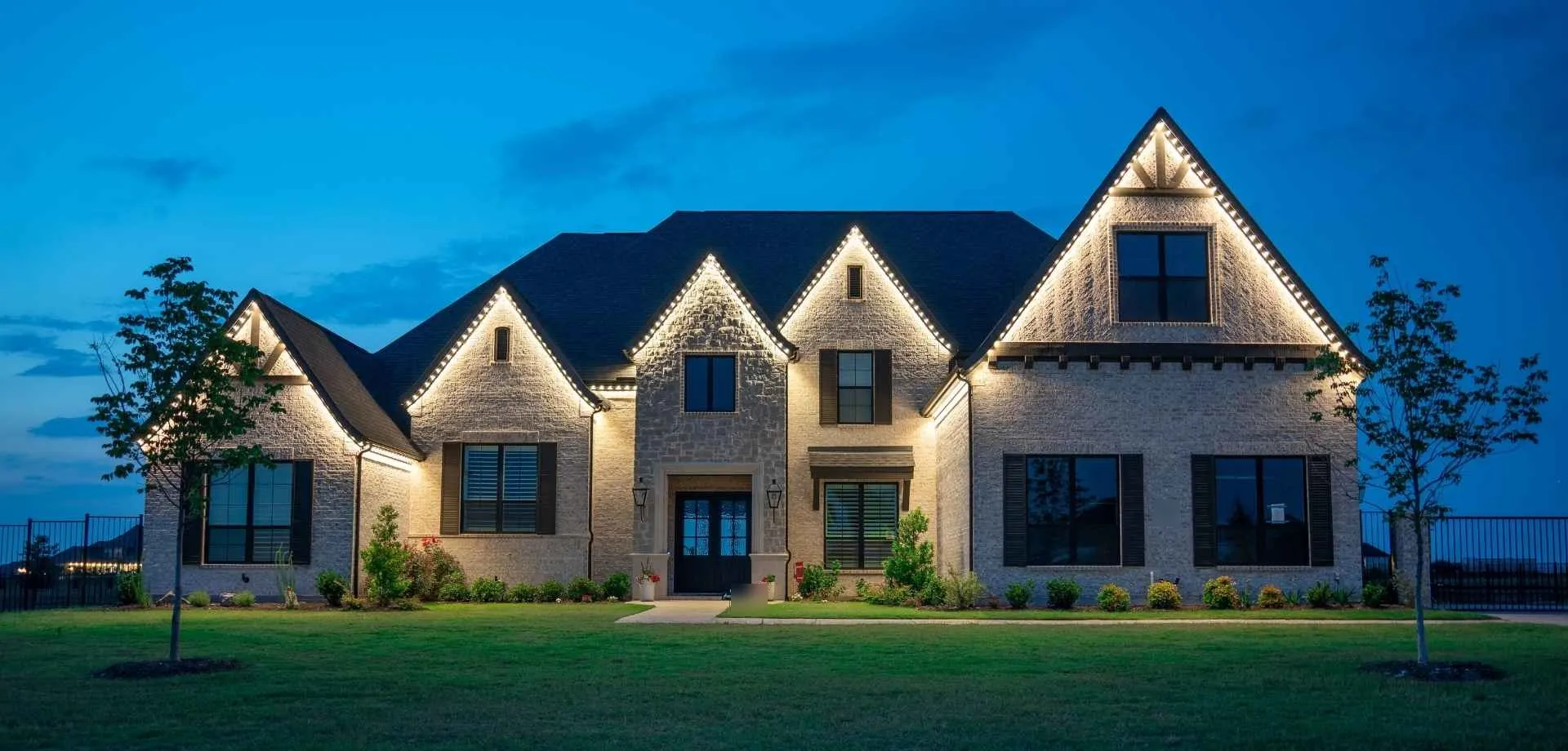 Roofline lit in bright colors by a permanent LED lighting system